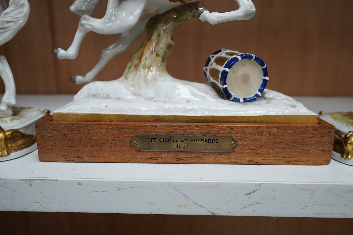 A group of three continental porcelain models of riders on horseback, tallest 27cm